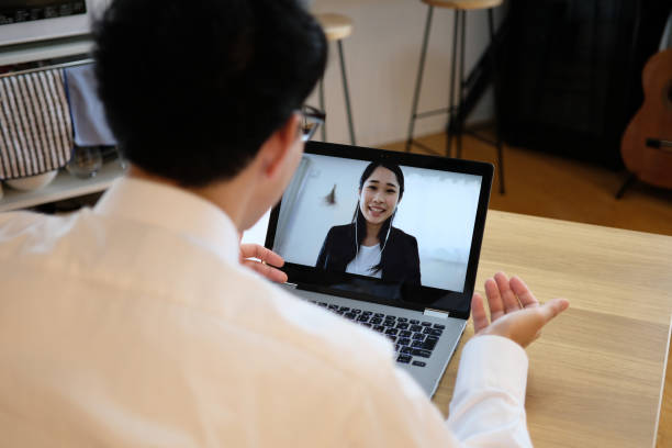 Asian businessman talking to colleague on web meeting