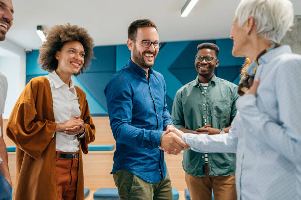 Happy businessman shaking hands with colleague on a meeting in the office.