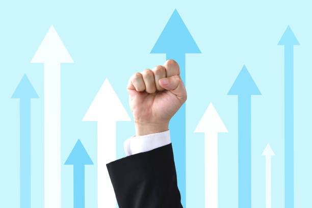 Business man's fist with upward arrows