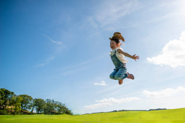 Girl jumping to the blue sky
