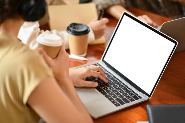 Female college student using laptop, studying in library. Education and youth lifestyle concept.