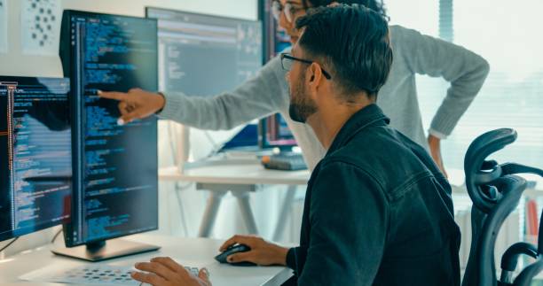 Tech team professionals collaborate discuss software development strategies in modern office. Software developer, artificial intelligence and programming concept.