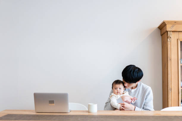 Dad working from home while taking care of his baby
